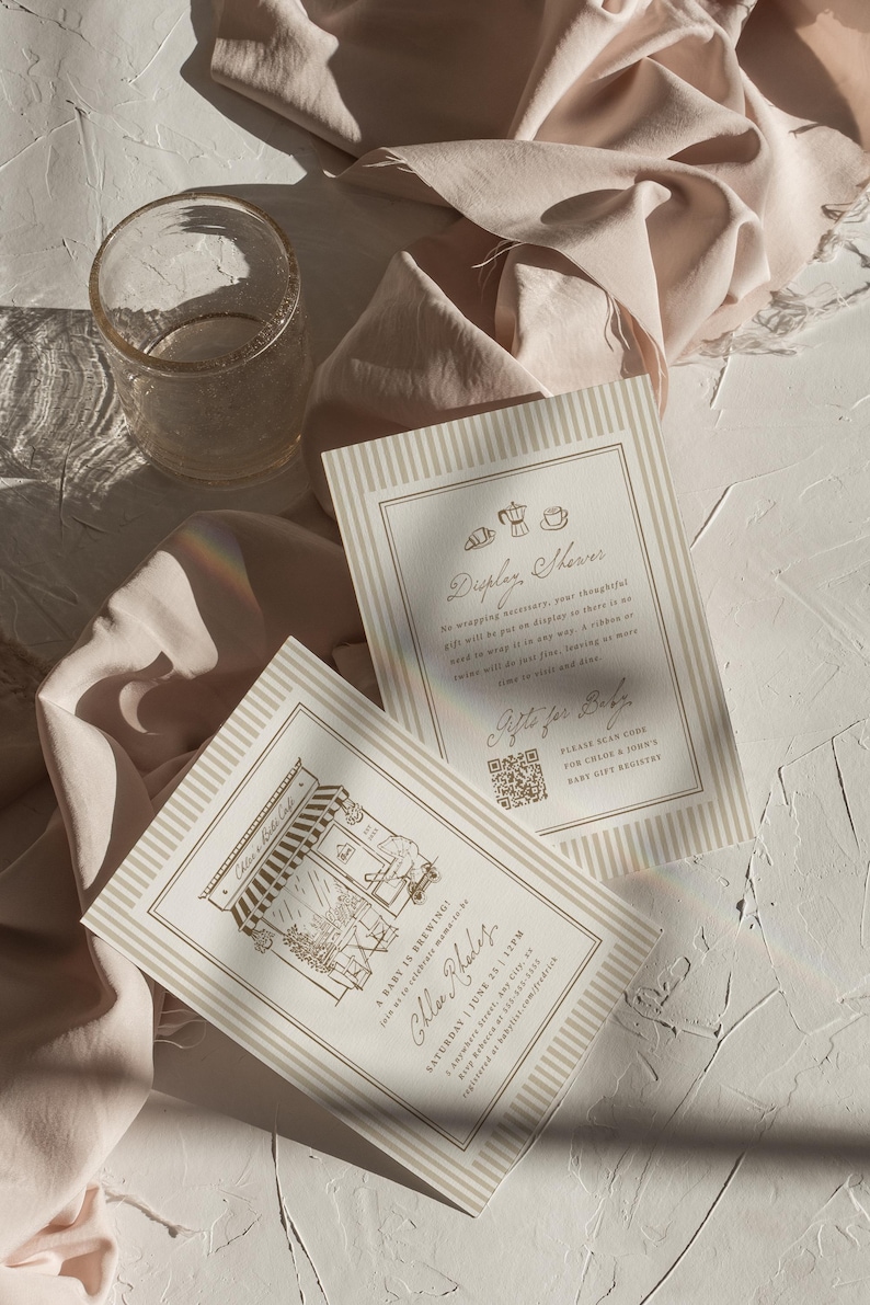 May include: Two rectangular cream-colored cards with beige vertical stripes. One card features a cafe illustration and text reading A Baby is Brewing, Chloe Rhodes, Saturday June 25, 12PM. The other card reads Display Shower and Gifts for Baby.
