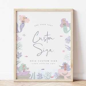 May include: A printable 8x10 inch sign with a mermaid theme. The sign features three mermaids with pink, purple, and green hair, surrounded by coral and seaweed. The text on the sign reads "Add your text Custom Sign 8x10 Custom Sign create unlimited signs".