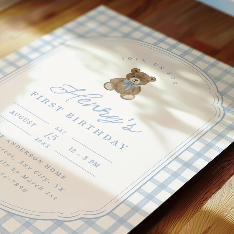 May include: A rectangular birthday invitation card featuring a light blue and white gingham border. The center displays a watercolor teddy bear with a blue bow, the text JOIN US FOR Henry's FIRST BIRTHDAY, and placeholders for date, time, and location details.