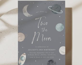 May include: A gray birthday invitation card featuring a space theme with a crescent moon, planets, and a rocket ship. The text reads: let's blast off Two the Moon in celebration of JULIAN'S 2ND BIRTHDAY! Saturday September 7th at 1pm 9 Ocean Drive | Malibu, California rsvp to Sarah at 555.555.5555.