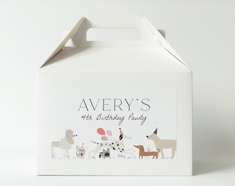 May include: White cardboard party favor box with a handle. The box has a sticker with the text "AVERY'S 4th Birthday Pawty" and an illustration of dogs wearing party hats.
