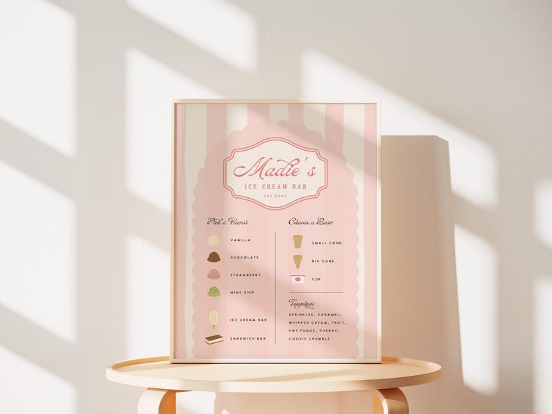 May include: A pink and white striped sign with the text "Maddie's Ice Cream Bar Est. 2023" in a pink script font. The sign lists ice cream flavors: vanilla, chocolate, strawberry, and mint chip. It also lists cone sizes: small cone, big cone, and cup. Toppings include: sprinkles, caramel, whipped cream, fruit, hot fudge, cherry, cookie crumbs.