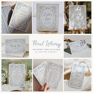 May include: A collection of light blue floral-themed stationery items. Includes invitations, signs, thank you cards, and game cards. The text "Floral Whimsy" and "Matching items available" are also visible.
