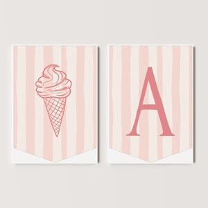 May include: Two pink and white striped banners with a pink ice cream cone on one and the letter A on the other.