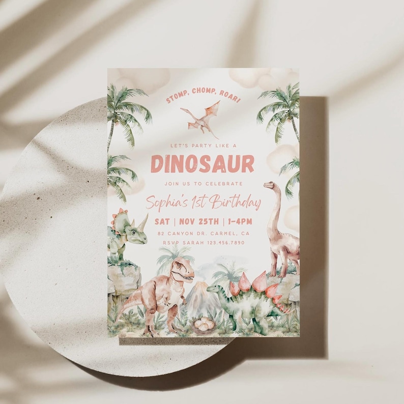 May include: A pink and green dinosaur-themed first birthday party invitation with a watercolour background. The invitation features a variety of dinosaurs, including a T-Rex, a stegosaurus, and a pterodactyl. The text on the invitation reads "Let's party like a dinosaur, join us to celebrate Sophia's 1st birthday, Sat Nov 25th 1-4pm, 82 Canyon Dr. Carmel, CA, RSVP Sarah 123.456.7850."