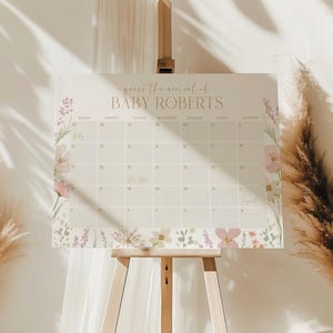 Peut inclure: Un tableau de jeu de baby shower beige clair avec le texte "Devinez l'arrivée de BABY ROBERTS" en lettres dorées. Le tableau comporte une grille de calendrier et est décoré d'illustrations florales roses, violettes et vertes. Il est exposé sur un chevalet en bois.