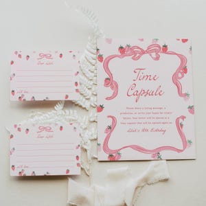 May include: Pink and white time capsule invitation with a strawberry and bow design. The invitation says "Time Capsule" and "Please share a loving message, a prediction, or write your hopes for Lila's future. Your letter will be placed in a time capsule that will be opened again on Lila's 18th birthday."