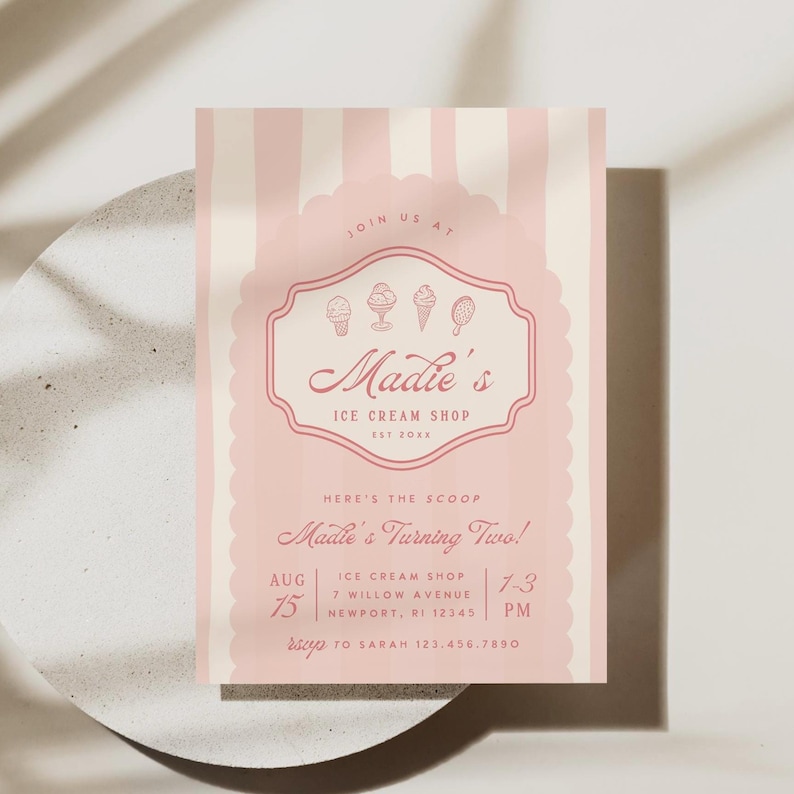 Puede incluir: Invitaci&oacute;n a rayas rosa y blancas con un logotipo rosa de tienda de helados para una fiesta de cumplea&ntilde;os. El logotipo dice "Madie's Ice Cream Shop Est 2028" y tiene una imagen de conos de helado. El texto dice "Join us at Madie's Turning Two! Ice Cream Shop 7 Willow Avenue Newport, RI 12345 Aug 75 1-3 PM RSVP to Sarah 123.456.7850"