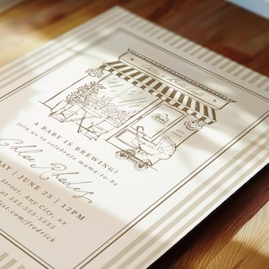 May include: A cream-colored invitation card with brown ink featuring a line drawing of a cafe storefront, a baby carriage, and the text: Chloe's Bibe Cafe, A BABY IS BREWING! join us to celebrate mama-to-be, Chloe Rhodes, DAY | JUNE 25 | 12PM.