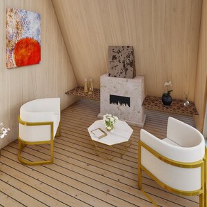 May include: A modern living room with two white chairs with gold frames, a white coffee table with a gold frame, and a fireplace with a stone surround. The room has wood floors and large windows.