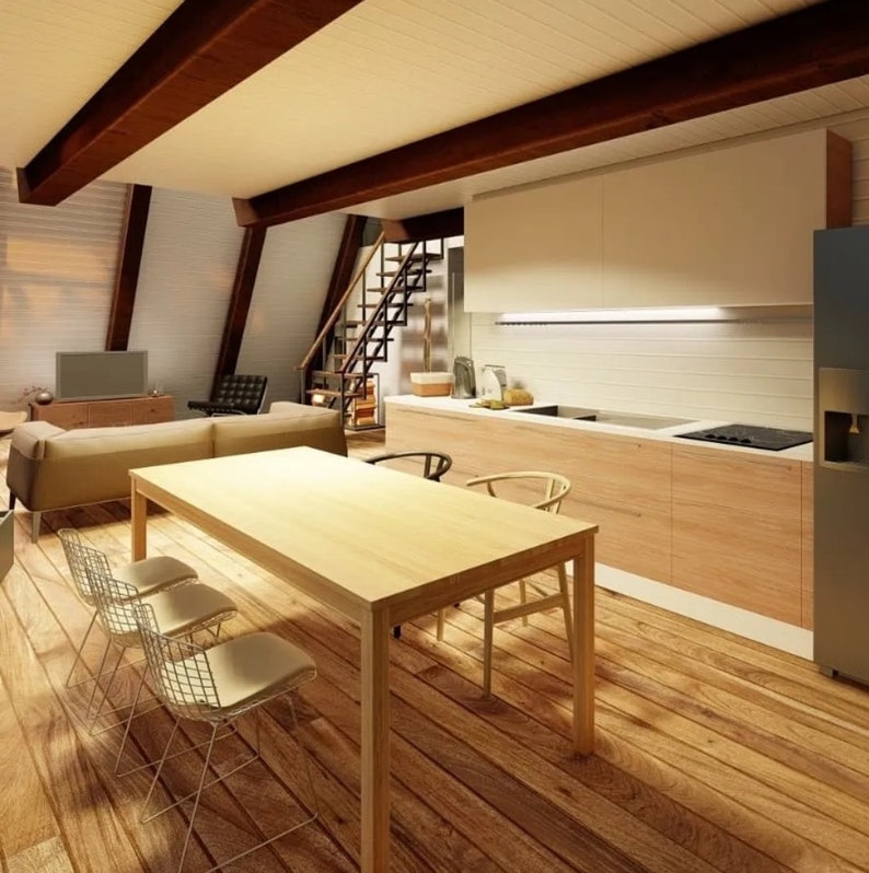 May include: A modern kitchen and dining area with a wooden table and chairs. The kitchen features white cabinets, a stainless steel sink, and a wood countertop. The dining area has a large wooden table with four chairs. The room has a wood floor and a vaulted ceiling with exposed beams.