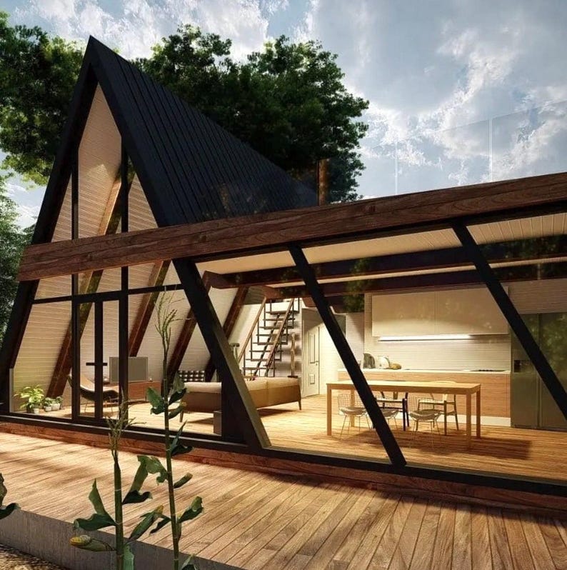 May include: A modern, triangular-shaped house with large windows and a wooden deck. The house has a black roof and a wooden frame. The interior of the house is visible through the windows, showing a living room with a couch and a dining room with a table and chairs.