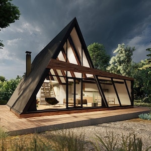 May include: A modern, black and wood A-frame house with large windows and a wooden deck. The house is surrounded by trees and bushes.