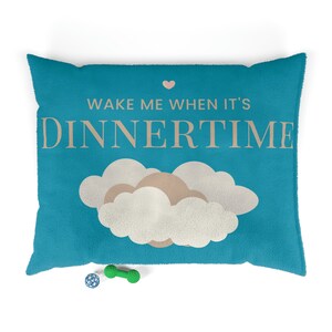 May include: A turquoise blue dog bed with a white cloud design and the text "Wake me when it's Dinnertime".