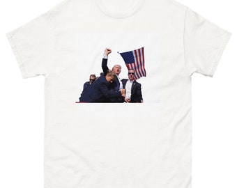Trump Resilience: Celebratory Fist Pump Tee - Patriotic American Flag Design