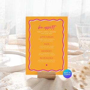 May include: A yellow and pink printable bridal shower menu card with the text "bon appetit" and the menu items listed: appetizers, main, dessert, and beverages. The text "Edit in Canva" is at the bottom of the card.