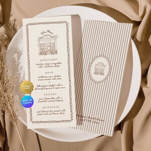 Pode incluir: Dois cartões de menu de casamento em um prato branco. O cartão de menu à esquerda tem uma borda decorativa e lista aperitivos, pratos principais, sobremesas e bebidas. O cartão à direita tem listras verticais e um design correspondente. O menu diz "The Menu" e "Cafe Bars".