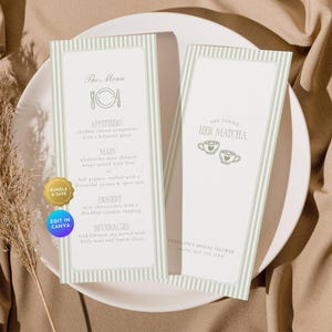 May include: Two wedding menu cards with a light green striped border and text. One card says "The Menu" and lists appetizers, main courses, dessert, and beverages. The other card says "She Found Her Matcha". Both cards are on a white plate.