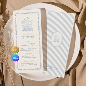 Puede incluir: Dos tarjetas de menú azul claro y blanco sobre un plato blanco. La tarjeta de menú de la izquierda tiene un borde decorativo e incluye elementos del menú como aperitivos, platos principales y postres. La tarjeta de la derecha tiene rayas verticales y el texto "Emily's Baby Shower".