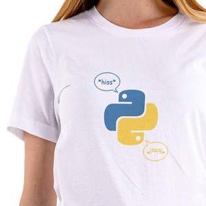 May include: White t-shirt featuring the Python programming language logo in blue and yellow, with speech bubbles saying "hiss" and "sssh". The shirt is a short-sleeved crew neck.