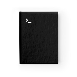 May include: A black notebook with a white command prompt symbol on the front.