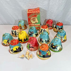 May include: A collection of conical Whirl-Glo revolving tree light shades featuring colorful illustrations of holiday scenes, including a Santa Claus box. The set includes various shades with printed graphics and small metal pin components.
