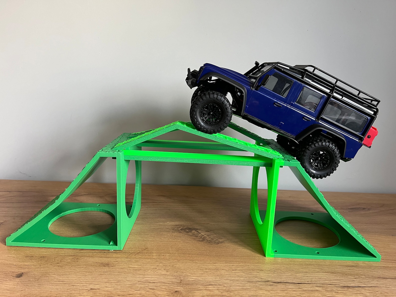 Modular RC crawler terrain setup with accessories in a UK countryside scene