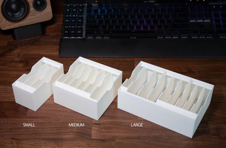 May include: Three white plastic storage boxes with dividers for organising small items. The boxes are labelled "Small", "Medium", and "Large".