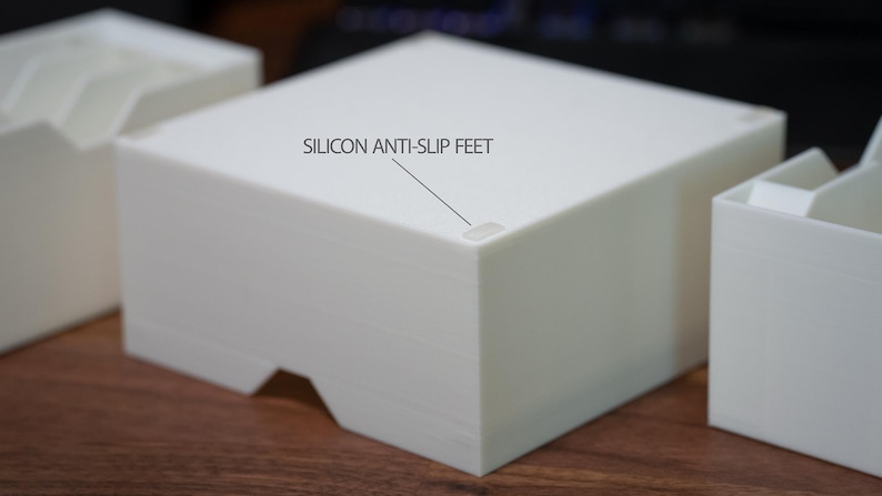May include: White rectangular storage box with a label that reads "SILICON ANTI-SLIP FEET". The box has small, clear silicone feet on the bottom.