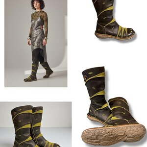 May include: Brown leather boots with olive green accents. The boots have a round toe and a mid-calf height. The design includes decorative stitching and a textured sole. The boots are shown in multiple views.