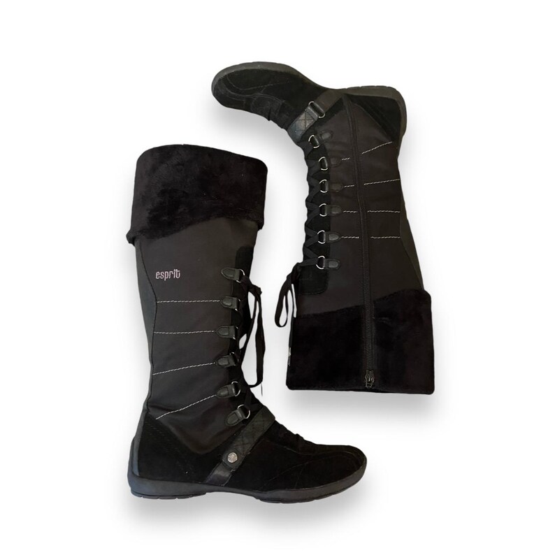 May include: A pair of black knee-high boots with a lace-up front and a zipper on the back. The boots have a black suede toe and heel. The boots are labeled "esprit" on the side.