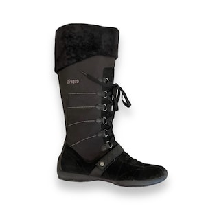 May include: Black suede and nylon lace-up boots with a zipper on the side. The boots have a padded collar and a rubber sole. The brand name "929" is printed on the side of the boot.