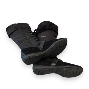 May include: Black winter boots with a lace-up front and a zipper on the side. The boots have a thick sole and a soft, padded collar. The brand name "esprit" is visible on the side of the boot.