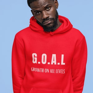 May include: Red hooded sweatshirt with the text "G.O.A.L. GROWTH ON ALL LEVELS" in white.