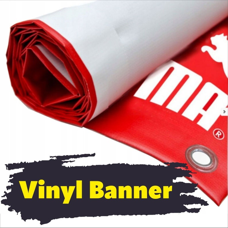 May include: A rolled-up red and white vinyl banner featuring a partial white logo and text that reads MA with a registered trademark symbol. The banner includes a visible metal grommet along the edge, showcasing a smooth, durable material.