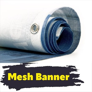 May include: A rolled-up white and blue mesh banner featuring a silver metal grommet on the edge. The material has a visible woven texture throughout. Below the banner, the text Mesh Banner is displayed in yellow on a dark brush stroke background.