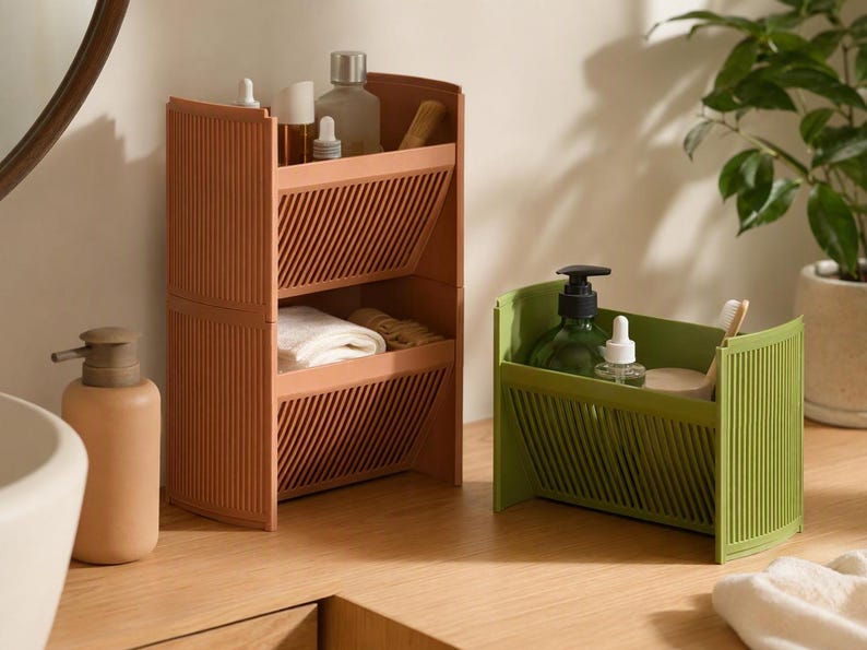 Tilt Stack angled storage: two-tier brown terracotta and green compact shelf bin with slatted fronts on a wooden vanity.