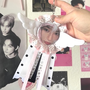 May include: A white ceramic mug with a black handle and the text "But First, Coffee" in a handwritten style. The mug is on a white surface. The mug is approximately 4 inches tall.