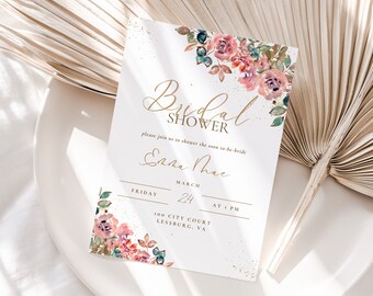 May include: A white bridal shower invitation with gold lettering and a watercolor floral design. The invitation reads "Bridal Shower" and includes the bride's name, "Entha Thae", the date, "March 24", and the time, "at 1 PM". The invitation also includes the location, "100 City Court, Lessburg, VA".