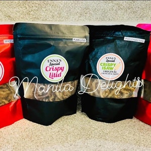 May include: Four bags of crispy snacks, labeled "Enna's Special Crispy Litid" and "Enna's Special Crispy Isaw". The bags are red, black, and pink, and the snacks are visible through clear plastic windows.