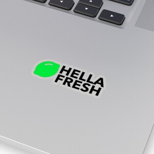 May include: A sticker featuring a green lime and the text "HELLA FRESH" in black.