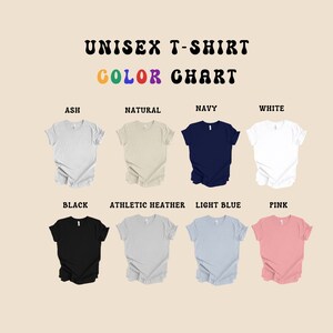 May include: Colour chart showing different t-shirt colours available. The colours are: Ash, Natural, Navy, White, Black, Athletic Heather, Light Blue, and Pink.