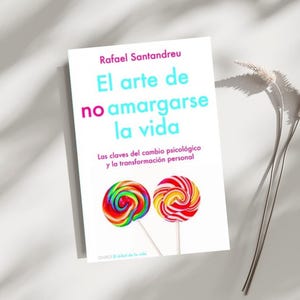 May include: Book cover with the title "El arte de no amargarse la vida" by Rafael Santandreu. The cover features two colorful lollipops on a white background.