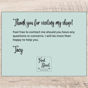 May include: A rectangular light blue thank you card with black text that reads: Thank you for visiting my shop! Feel free to contact me should you have any questions or concerns. I will be more than happy to help you. Jacy. First Street Paperie.