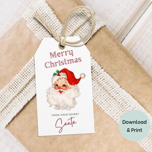 May include: White gift tag with a red and white illustration of Santa Claus. The tag reads "Merry Christmas" and "From your secret Santa".