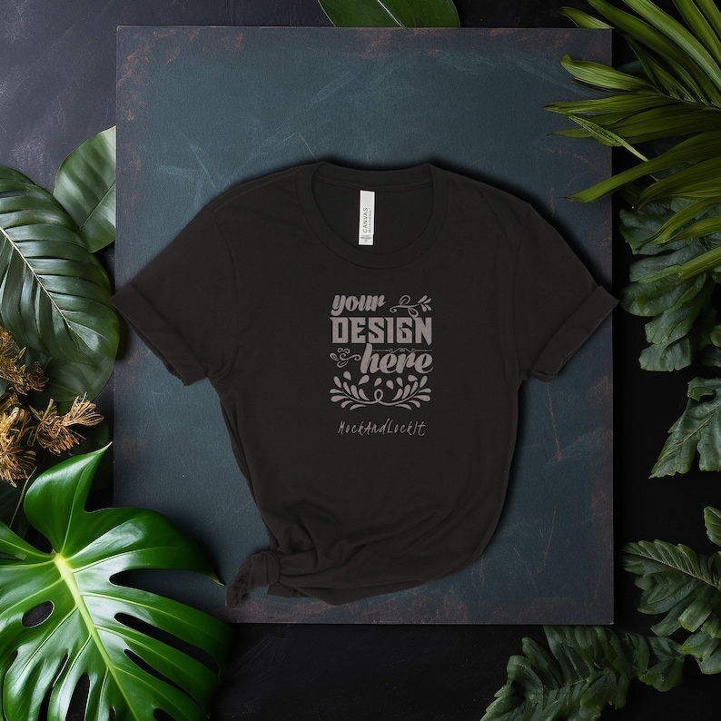 May include: Black t-shirt with the text "your design here" and "NextAndLcklt." in a light gray color.
