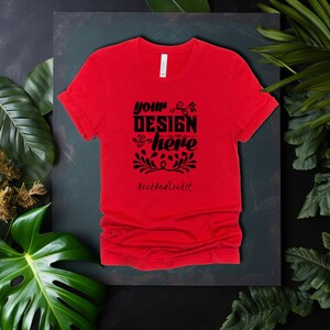 May include: Red t-shirt with a black design that says "your design here" and "RockAndLockIt" in a decorative font.