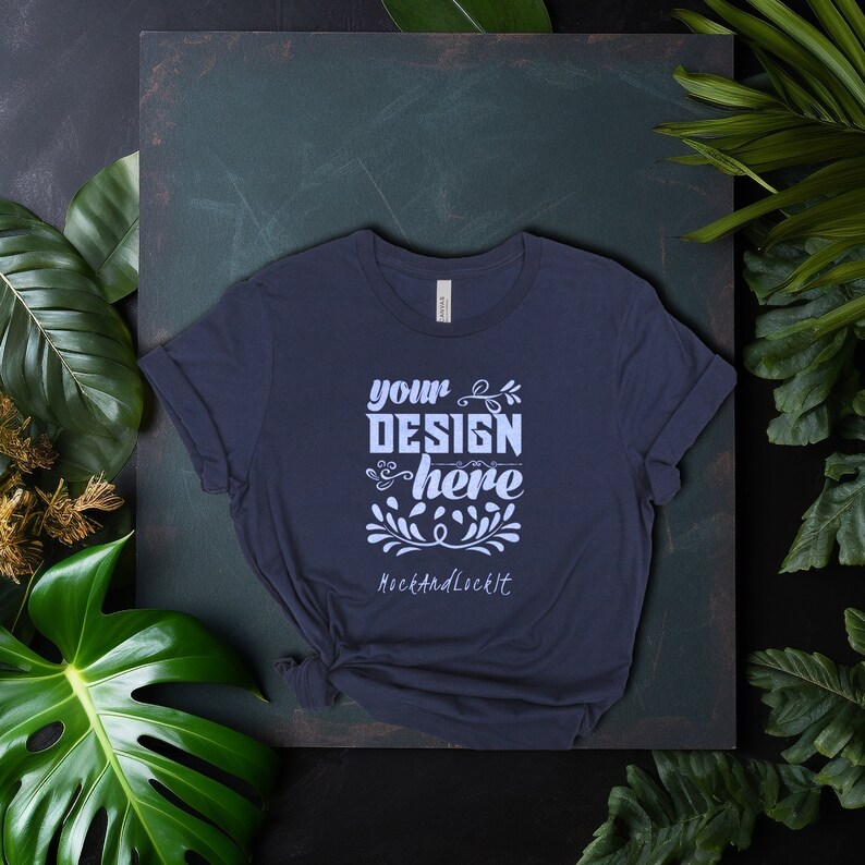 May include: A dark blue t-shirt with a white design that says "your design here" and "Rock and Lock It" on a dark green background.
