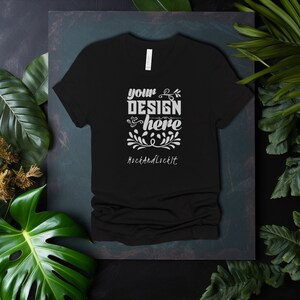 May include: Black t-shirt with a white design that says "your design here" and "MockAndLockIt" on a dark green background.