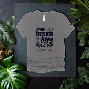 May include: A heather gray t-shirt with a design that says "your design here" with a floral design and the text "MockAndLockIt" below.